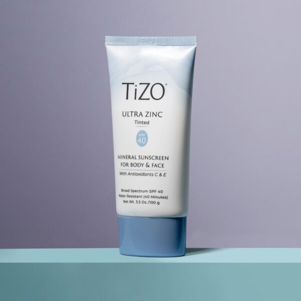 Product photo showing blue bottle with a light purple background